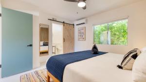 a bedroom with a large bed and a window at Good Vibes Only by AvantStay Modern Chic Grill Fire Pit Hammocks in Joshua Tree