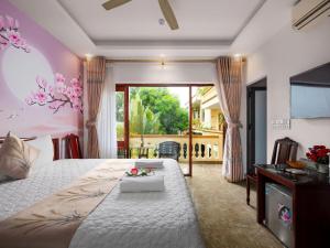 a bedroom with a large bed and a balcony at Lys Homestay in Ninh Binh +218 photos