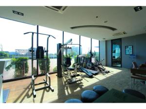 a gym with several exercise bikes in a room with windows at Royal King Suite in Bang Bo
