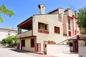an old building with a chimney on a street at B&B Il Colle in Otricoli