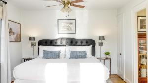 a bedroom with a white bed with a ceiling fan at Whitney by AvantStay Private Berkshires Estate in Sheffield
