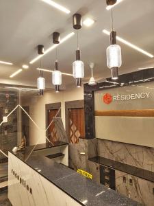 a restaurant with several pendant lights hanging from the ceiling at M S RESIDENCY in Chennai