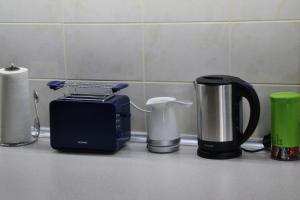 a counter top with a toaster and a coffee maker at Skopje Hostel in Skopje