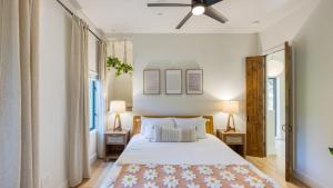 a bedroom with a large bed and two lamps at Mill Creek by AvantStay Modern Design Patio Hot Tub in Healdsburg