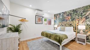 a bedroom with a bed and a wall mural at Urban Jungle by AvantStay A Location Steps to Hollywood Must-Sees in Los Angeles