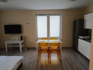 a kitchen with a table and four chairs in a room at Apartament Rodzinny in Oława