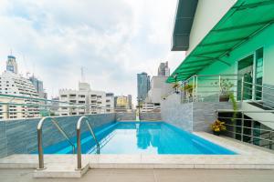 a swimming pool on the roof of a building at KS RESIDENCE Victory Monument in Bangkok