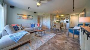 a living room with a couch and a table at Sleeps 18 2 Beachfront Condos w 2 Pools TennisPickleball Beach Boardwalk in Port Aransas