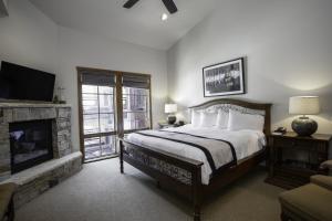 a bedroom with a large bed and a fireplace at 3 Bedroom Condo with Spa - Silver Baron Lodge condo in Park City