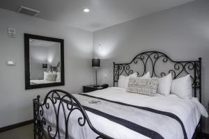 a bedroom with a black and white bed with a mirror at 3 Bedroom Condo with Spa - Silver Baron Lodge condo in Park City