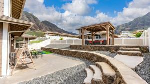 a patio with rocks and a gazebo at Makaha Villa by AvantStay Mountain Ocean Views in Waianae