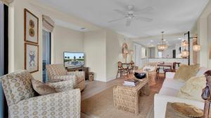 a living room with couches and a dining room at 303A Shipwatch by AvantStay Ocean View Shared Pool Boardwalk to Beach in Isle of Palms