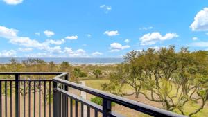 a balcony with a view of the ocean at 303A Shipwatch by AvantStay Ocean View Shared Pool Boardwalk to Beach in Isle of Palms
