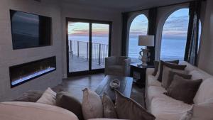 a living room with a couch and a view of the ocean at 412 Seascape by AvantStay Oceanfront Balcony in Isle of Palms