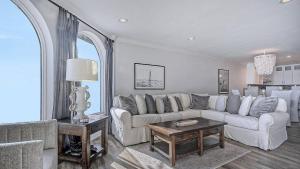 a living room with a white couch and a table at 412 Seascape by AvantStay Oceanfront Balcony in Isle of Palms