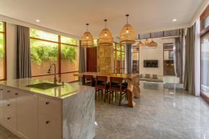 a kitchen with a table and a dining room at Sepa Island Resort in Pulau Tondan Barat