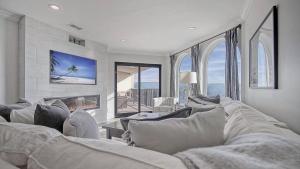 a living room with a couch and a fireplace at 412 Seascape by AvantStay Oceanfront Balcony in Isle of Palms