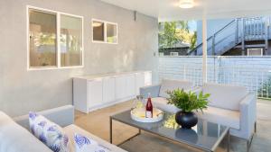a living room with two couches and a table at Fulton Buyout by AvantStay Sherman Oaks Estate View in Los Angeles