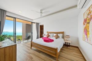 a bedroom with a bed and a large window at Villa Fanta Sea - Luxury Residence at Chaweng Noi in Koh Samui  +45 photos