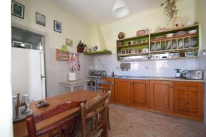 a kitchen with wooden cabinets and a wooden table at Eftopia Martino Pansion in Martínon