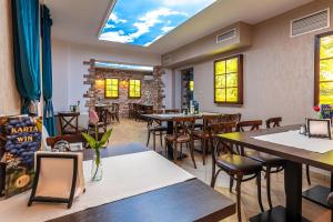 a restaurant with tables and chairs in a room at Old Tree Villa & Restaurant in Oświęcim