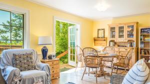 a living room with a table and chairs at Smugglers Lagoon Beach Cottage by AvantStay in Greenbank