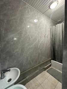 a bathroom with a sink and a shower at Golden Square in Almaty