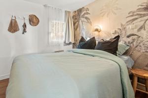 a bedroom with a bed with a green comforter at La Bohême in Grimaud +27 photos