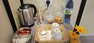 a table with a basket of food and bottles on it at Seaside Dhangethi Inn in Dhangethi