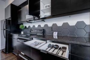 a kitchen with a stove and a sink in it at Chic Midtown Hideaway Top floor with Balcony in Atlanta