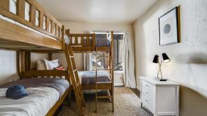 a bedroom with two bunk beds and a window at Marillac by AvantStay Gorgeous Ski Cabin w Balcony Patio in Olympic Valley