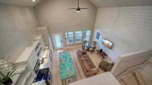 an overhead view of a living room with a staircase at Pool Access Boat Dock Steps to the Gulf The Pintail by AvantStay in Padre Island
