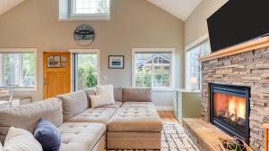 a living room with a couch and a fireplace at Sunny Backyard Fireplace Coastal Access in Peaceful Neighborhood Near Shopping in Langley