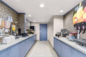 a restaurant with blue counters and a blue door at Clarion Inn Cranberry Township in Cranberry Township