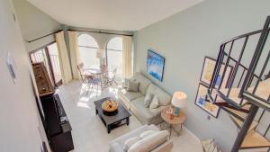 a living room with a couch and a table at 512 Seascape by AvantStay Oceanfront Condo on the Beach Community Pool Access in Isle of Palms