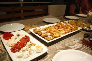 a table with two plates of food on it at Hotel Marant in Sozopol