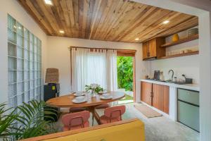 a kitchen and dining room with a wooden ceiling at THE LOFT - Super Central General Luna in General Luna