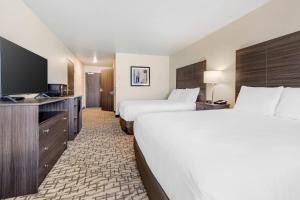 a hotel room with two beds and a flat screen tv at Comfort Inn & Suites Medina in Medina +56 photos
