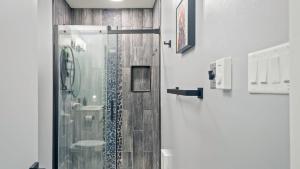 a shower with a glass door in a bathroom at Lakeside Haven Ping Pong Fire Pit Mins to Big Boulder Lake Harmony in Lake Harmony +30 photos