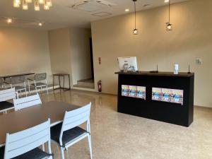 a room with a table and chairs and a television at HOTEL PAIKAJI - Vacation STAY 52773v in Ishigaki Island