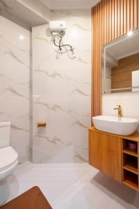a bathroom with a sink and a mirror at Luxury 3 bedroom apartment in lekki cadogan estate in Ikota