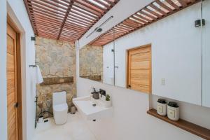 a bathroom with a white toilet and a sink at THE LOFT - Super Central General Luna in General Luna +49 photos