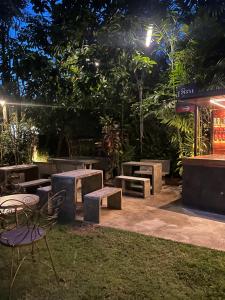 a patio with tables and chairs at night at Chern Chiangmai Boutique Hotel in Chiang Mai