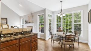 a kitchen with a table and chairs and a dining room at Fairview Vista by AvantStay 10 Mins to Asheville in Fairview