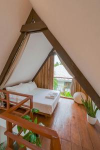 a bedroom with a bed in an attic at THE LOFT - Super Central General Luna in General Luna