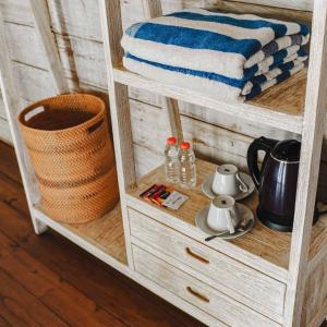 a wooden cabinet with towels on the shelf at Java Wood in Gili Trawangan