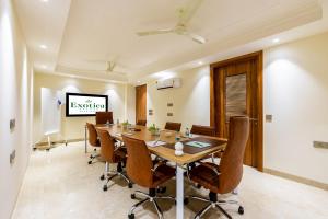 a conference room with a long table and chairs at Hotel Exotica Avenue - Business-Friendly Stay, Golf Course Road, Cyberhub, One Horizon Center & Metro in Gurgaon