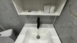 a bathroom with a sink and a toilet at Новое ЖК in Semey