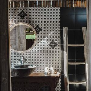 a bathroom with a sink and a mirror at Java Wood in Gili Trawangan