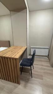 a desk and a chair in a room at Новое ЖК in Semey